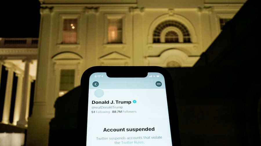 A photo illustration shows the suspended Twitter account of US President Donald Trump on a smartphone and the White House in Washington, US. Credit: Reuters Photo