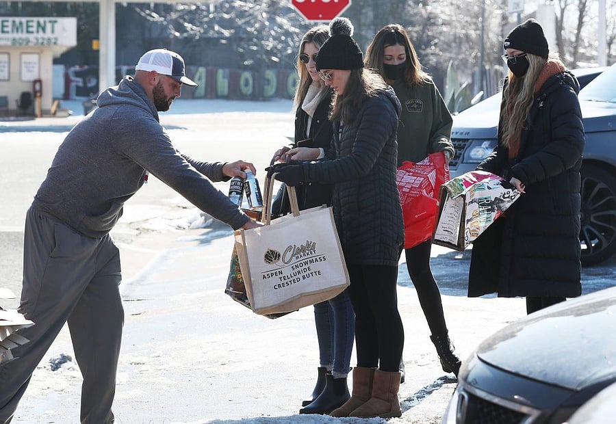 Owen Church gives out bottles of Rain Pure Mountain Spring Water to people in need in Austin, Texas. Credit: AFP photo. 