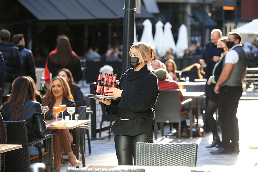 Customers enjoy a drink in the outside seating area of a pub in Leeds, northern England as coronavirus restrictions are eased across the country in step two of the government's roadmap out of England's third national lockdown. Britons on Monday toasted a significant easing of coronavirus restrictions, with early morning pints -- and much-needed haircuts. Credit: AFP Photo