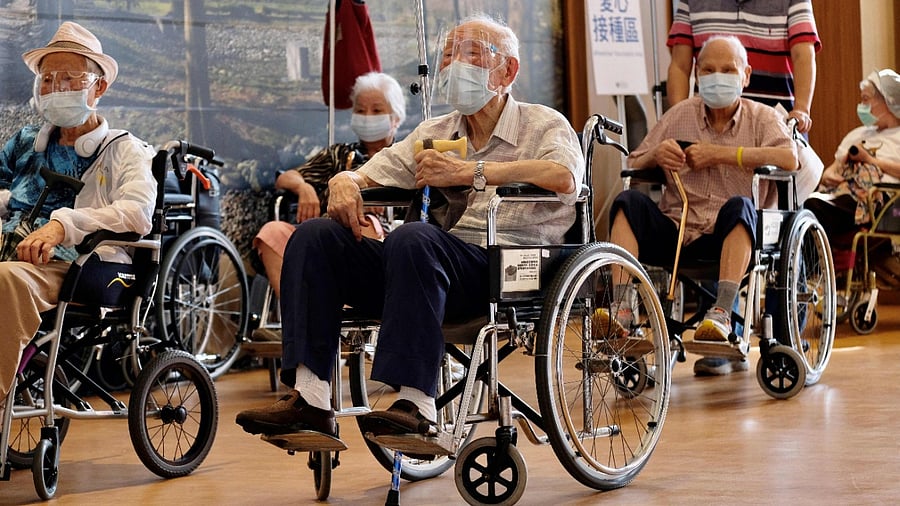 Elderly people queue to be vaccinated against Covid-19 coronavirus at the Hsinchuang Stadium in New Taipei City. Credit: AFP Photo