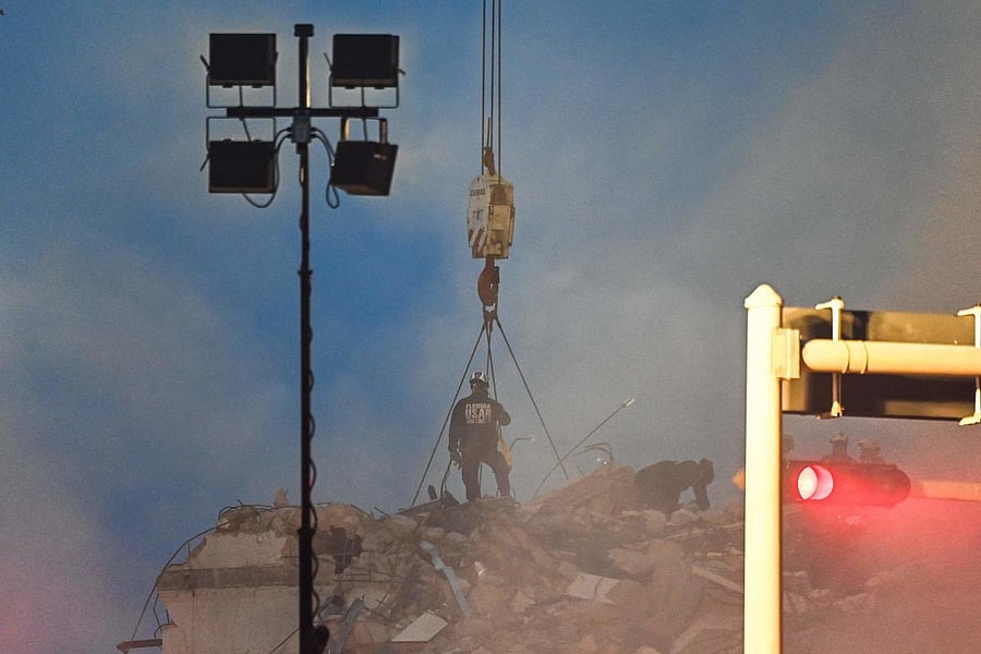 Rescue workers look for survivors among the debris of a partially collapsed building in Surfside, north of Miami Beach. Credit: AFP Photo