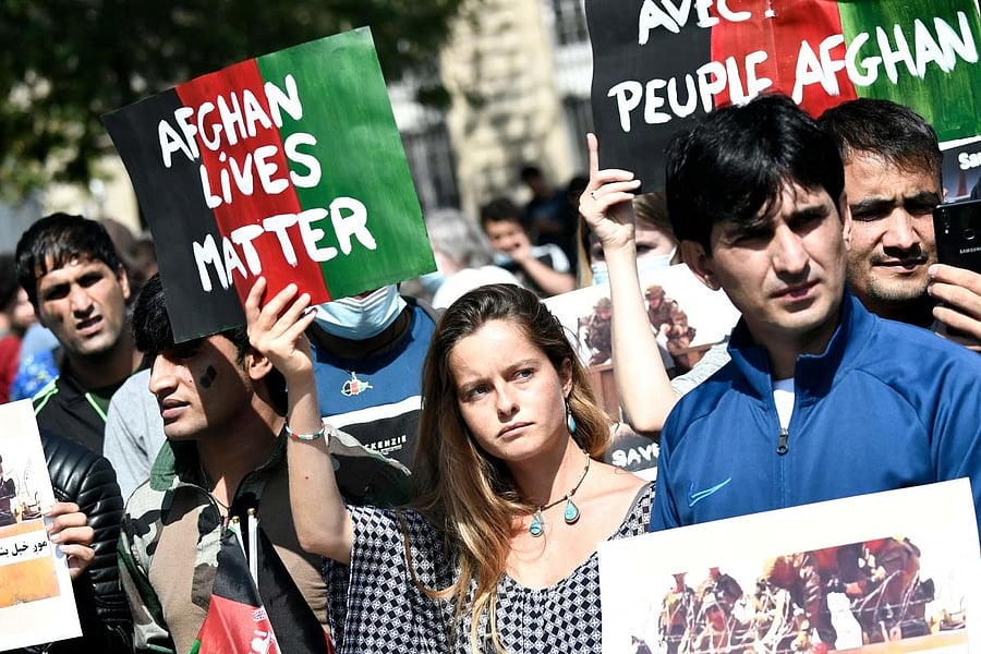 Protesters hold banners during a rally in support for Afghanistan following the take over of the country by the Taliban, at Place de la Republique in Paris. Credit: AFP Photo