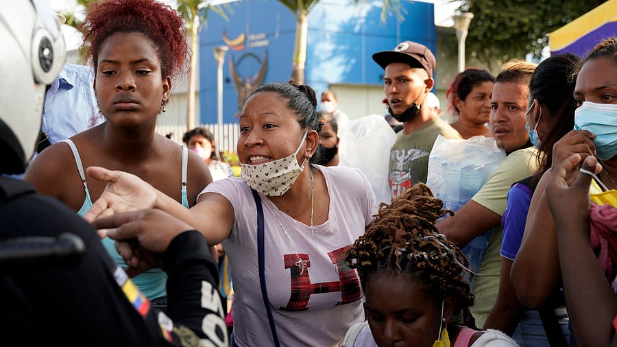 Family members of inmates speak with a police officer while waiting outside a morgue to identify the dead after a riot broke out at the Penitenciaria del Litoral prison, in Guayaquil, Ecuador. Credit: Reuters Photo