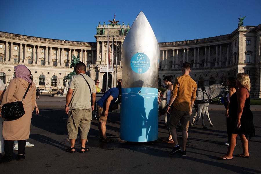 People refresh at a water dispenser in Vienna, Austria. Credit: AFP Photo