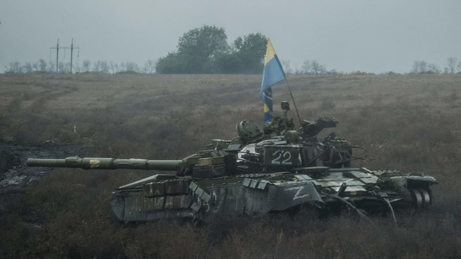 A Ukrainian flag is put on an abandoned Russian tank near Dolina in the Donetsk region, on October 10, 2022, amid the Russian invasion of Ukraine. Credit: AFP Photo