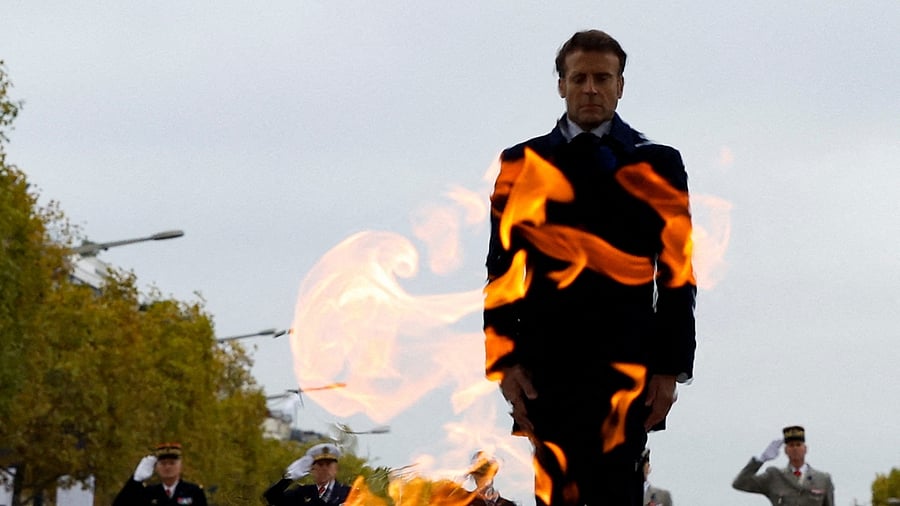 French President Emmanuel Macron stands in attention in front of the Tomb of the Unknown Soldier during a ceremony at the Arc de Triomphe in Paris on November 11, 2022, as part of commemorations marking the 104th anniversary of the November 11, 1918 Armistice, ending World War I (WWI). Credit: AFP Photo