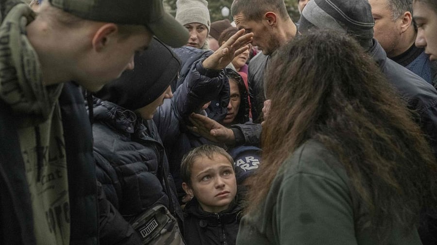 Local residents attend an aid supply distribution in the centre of Kherson on November 17, 2022. Credit: AFP Photo