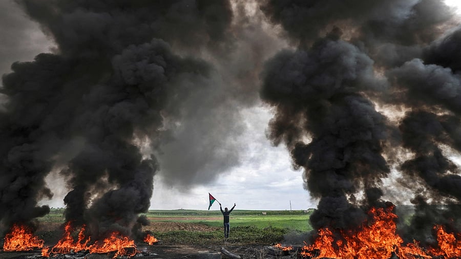 Palestinian youths burn tyres during a protest near the Israel-Gaza border east of Jabalia refugee camp, on February 23, 2023. Credit: AFP Photo