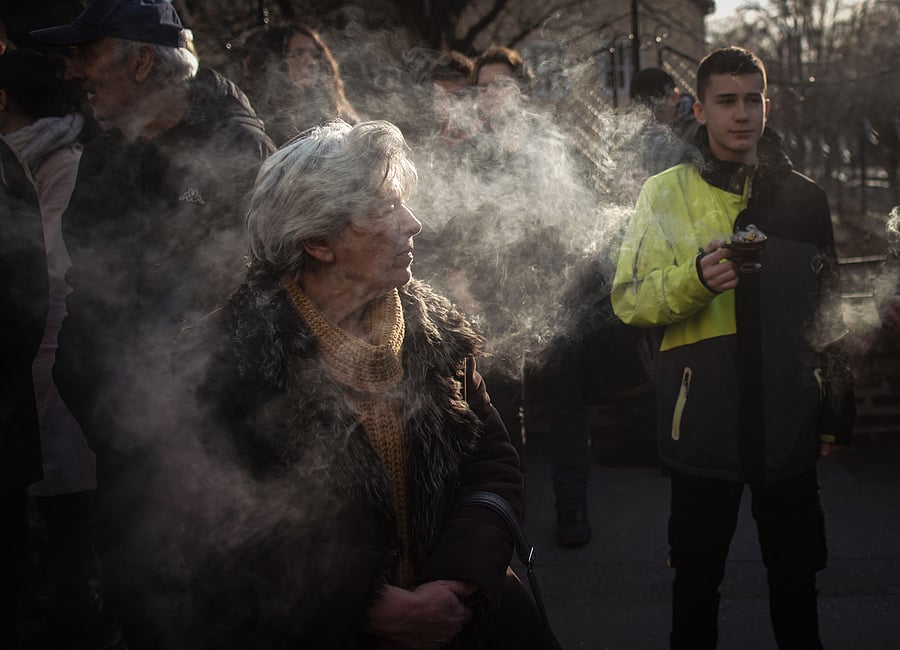 An Orthodox Christian lights an incense stick during the "Litiya Orthodox Church against the French-German plan for the resolution of Kosovo" demonstration in Belgrade. Credit: AFP Photo