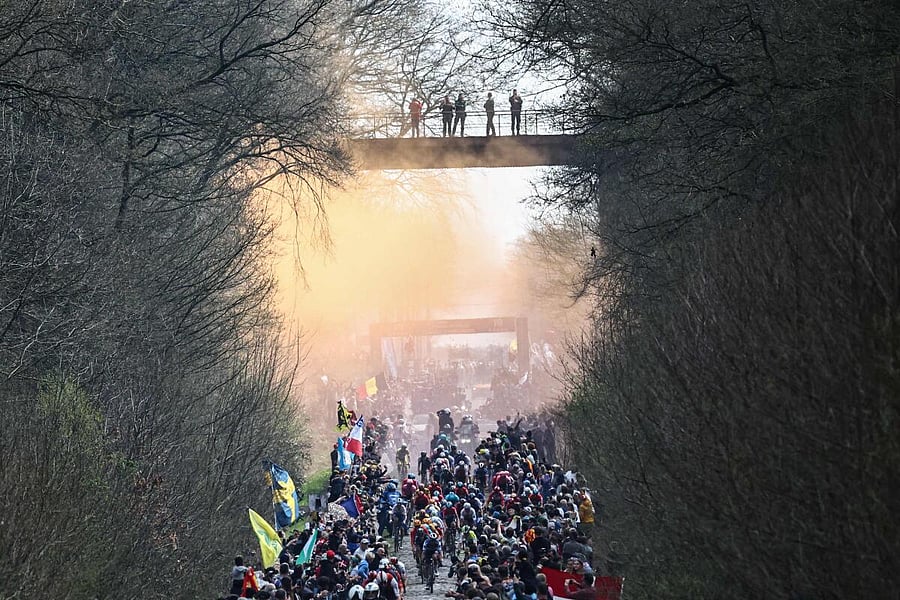 The pack of riders cycles over the Trouee d'Arenberg cobblestone sector during the 120th edition of the Paris-Roubaix one-day classic cycling race, between Compiegne and Roubaix, northern France. Credit: AFP