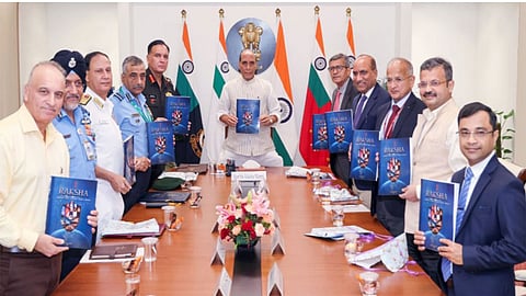 Alt="Defence Minister Rajnath Singh unveils 'RAKSHA' document"