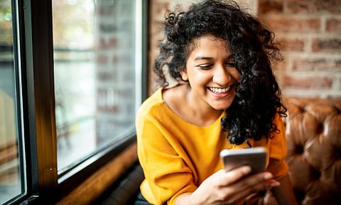 indian women with a mobile phone smiling
