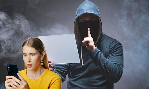 A cyber hacker and a women looking into the phone