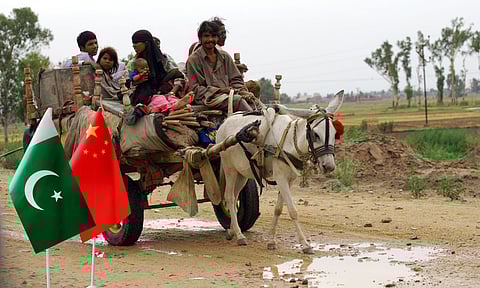 a family travelling in  a donkey cart, chinese and pakistan flags
