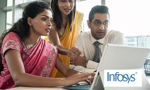 three people working on a computer infosys logo