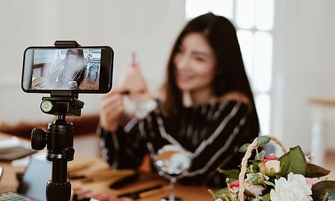 beauty blogger live broadcasting cosmetic makeup tutorial on social media. vlogger recording vlog video. influencer marketing
