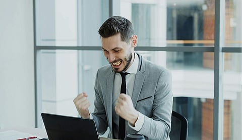 Excited Businessman Celebrating Success at Work