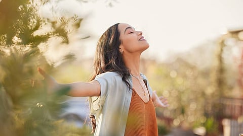 Serene latin woman enjoy sunset with gratitude