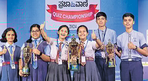 Niyati Jois and Rhythm Srivastava of Army Public School, Bengaluru, (centre) emerged champions in the final of Prajavani Quiz Championship 2024 held in Bengaluru on Monday. Manasi Shyam and Brinda Satyapriya of Taralabalu Jagadguru High School, Davangere (left), clinched second prize while J Chinmay and S Chirag of Excel Public School, Mysuru, bagged third prize. 