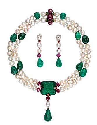 Cartier necklace made of pearls around and an extraordinary emerald stone. It was carved during the time of the Moghuls, in India (circa 17th century) This necklace has been made to commemorate the second Millennium, in the year 2000. Qatar Museum collections.