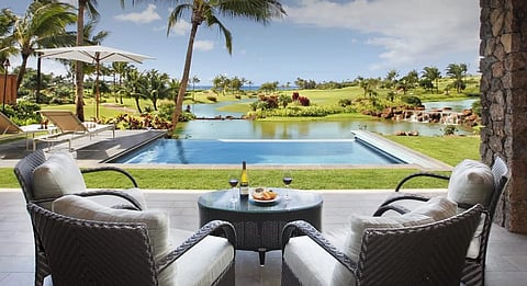 A private lanai overlooking Kukui‘ula’s lush landscape and oceanfront serenity