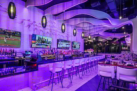 STK Westwood bar with sculptural LED ceiling ribbons and glowing purple lighting