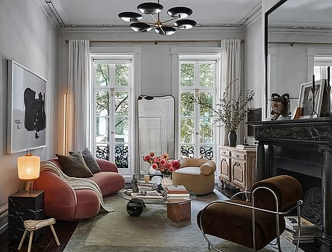 Narrative-driven living room layers sculptural seating, curated art, and vintage details to create an intimate, emotionally resonant space