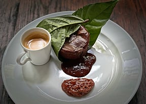 Molten chocolate cake wrapped in cacao leaf, with cacao pulp jam and espresso. PHOTO BY ADAM WAXMAN/DINE MAGAZINE