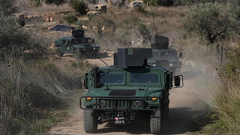 A convoy of Lebanese army vehicles drives near the border with Israel in the village of Alma al-Shaab during a Lebanese army media tour in south Lebanon