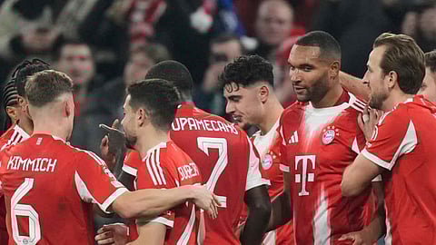 Bayern Munich players celebrate after Bayern's Jonathan Tah, second right, scored his side's third goal during the Champions League opening phase soccer match between FC Bayern Munich and Sporting CP in Munich, Germany, Tuesday, Dec. 9, 2025 