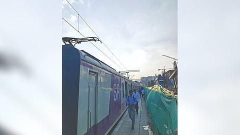 Passengers walk through the narrow platform due to ongoing development works at Egmore railway station