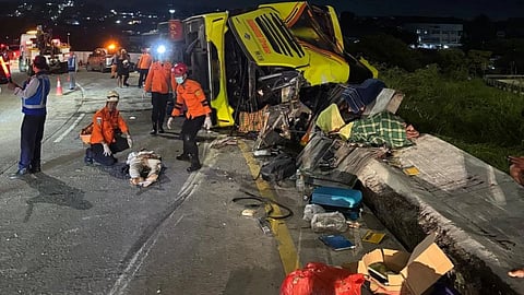 In this photo released by the Semarang Search and Rescue Office, rescuers tend to a victim of a deadly bus crash on a toll road in Semarang, Central Java, Indonesia, Monday, December 22, 2025. 