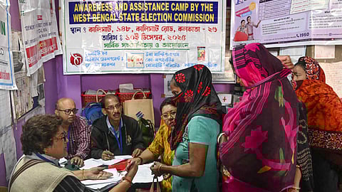 A voter checks his name from West Bengal's draft electoral rolls following special intensive revision (SIR), in Siliguri, West Bengal, Friday, Dec. 19, 2025