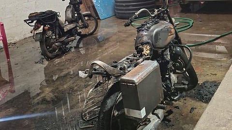 two bikes parked in front of a building owned by a Hindu Munnani functionary were set ablaze by an unidentified person