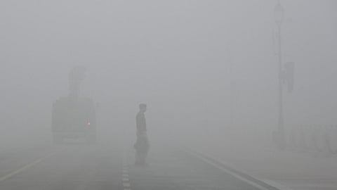 Fog covers the road making it difficult for people to travel.