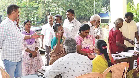 Voters checking their names in the draft roll