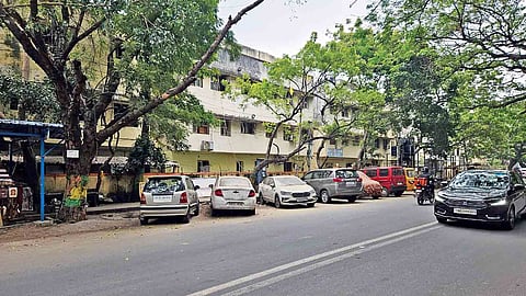 Vehicles parked on the streets, especially right outside the compound walls of apartments in Anna Nagar