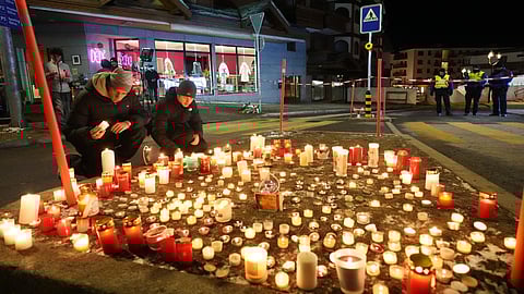 People lay candles near the Le Constellation bar, where a devastating fire left dead and injured during the New Year's celebrations in Crans-Montana, Swiss Alps, Switzerland