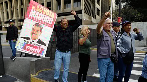Supporters display a poster of Venezuelan President Nicolás Maduro in Caracas, Venezuela, Saturday, Jan. 3, 2026, after U.S. President Donald Trump announced Maduro had been captured and flown out of the country.  