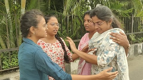 The woman (in white Churidar) is being consoled by friends