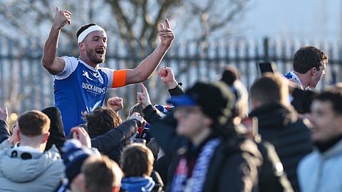 Goalscorer Paul Dawson hoisted by fans after the victory 