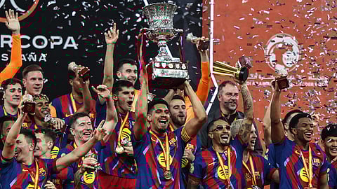 Barcelona players celebrate with the title 