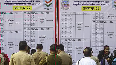 Polling officials collect EVMs and other election material at a distribution centre ahead of Brihanmumbai Municipal Corporation election, in Mumbai, Wednesday, Jan. 14, 2026 