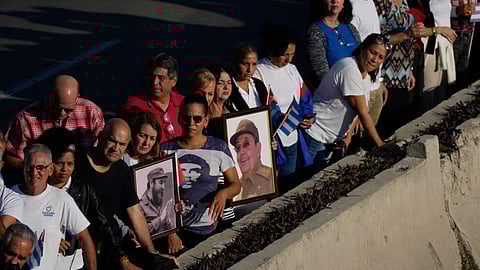 People line the streets of Havana, Cuba to watch the motorcade carrying urns containing the remains of Cuban officers killed during the US operation in Venezuela that captured Venezuelan President Nicolas Maduro
