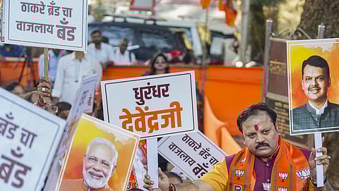 BJP workers hold placards during celebrations of their party's victory in the BMC elections, in Mumbai, Friday, Jan. 16, 2026 