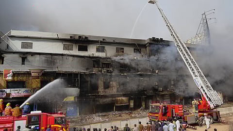 Firefighters try to control a massive fire that was broke out in a multi-story shopping mall in overnight, in Karachi, Pakistan
