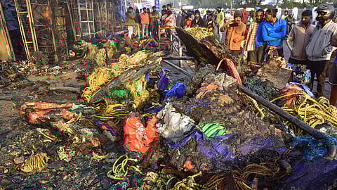 People salvage goods from the charred remains of shops after a major fire incident at Unit-I Haat, in Bhubaneswar, Tuesday, Jan. 20, 2026. Over 40 shops were gutted in the fire that broke out late Monday night. 