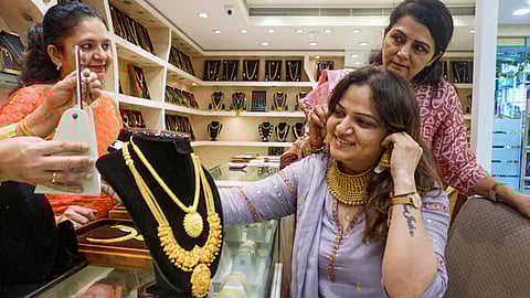 Image of a woman purchasing gold used for representative purpose