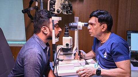 Ophthalmologist checks the patient's eye 