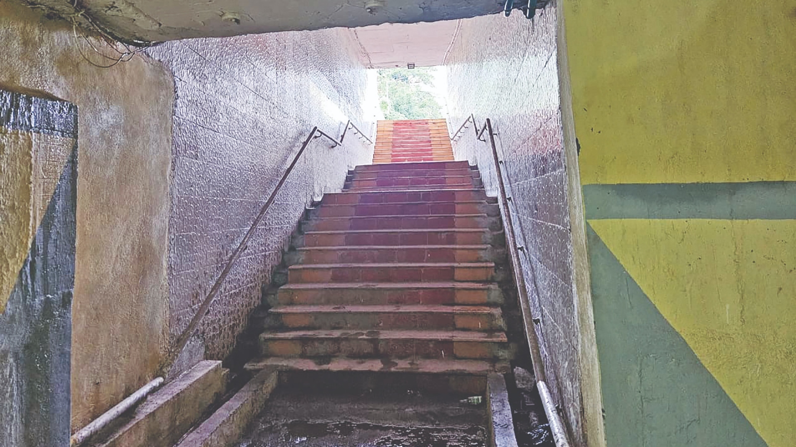 Dimly lit subway frequented by men for alcohol consumption 